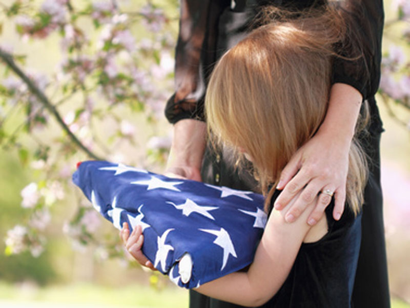 Family in mourning holding a flag